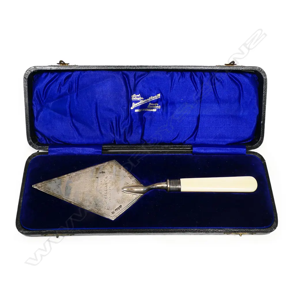 A cased presentation silver foundation laying trowel - engraved 'Presented to W.H. Ross Esq. On The Occasion Of Laying The Foundation Stone Of The St. Albans Presbyterian Church January 31st 1925’. Ivory handle. L.250mm. 96gms. In original leather fitted case. Image 1++