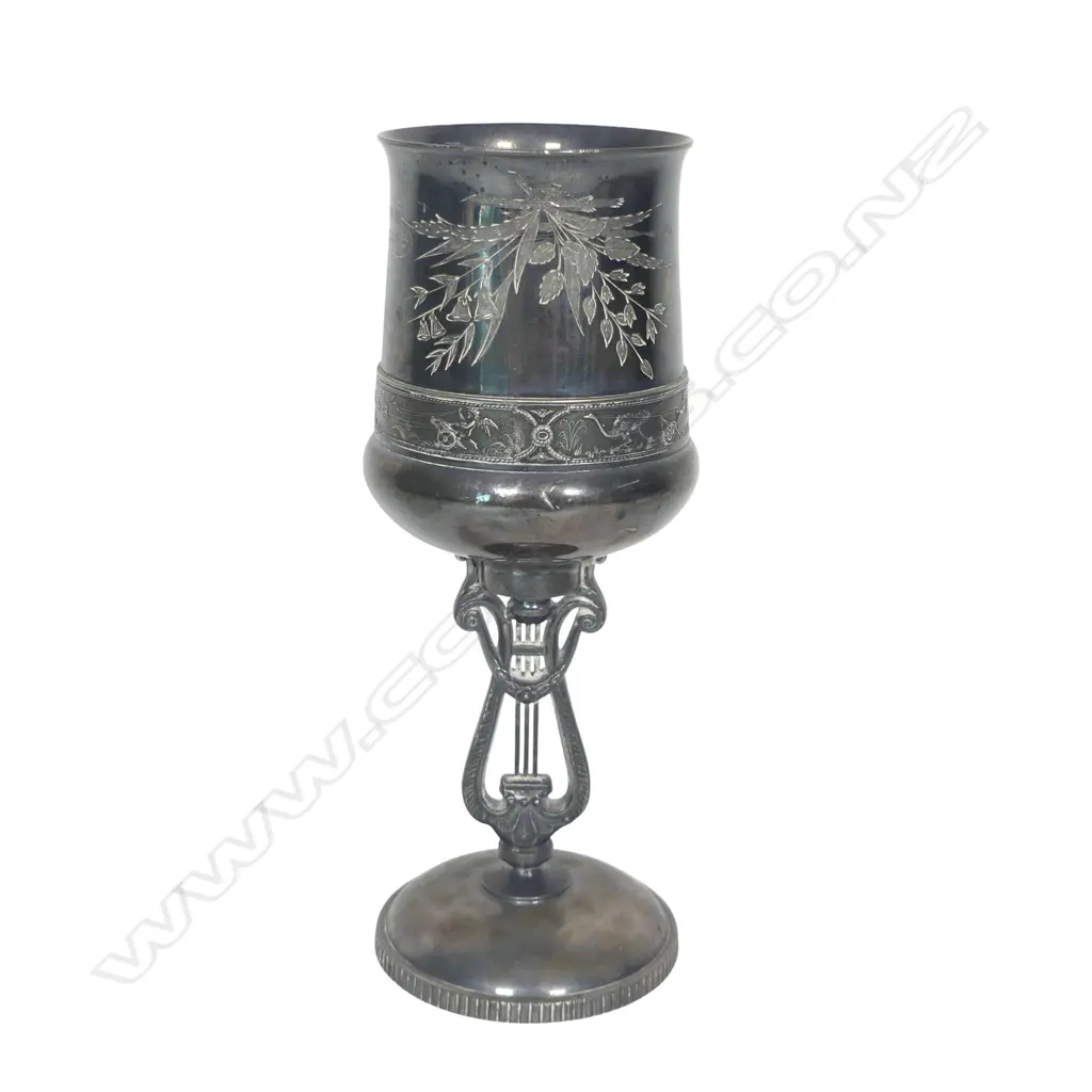 A late 19thC New Zealand historical silver plate trophy cup - presentation engraved ' Auckland Bowling Club 1883.4 Won By J Miller, Skip.'. The column support as a lyre. Tarnished. H.215mm. Image 1++