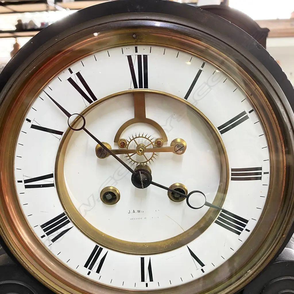 A Victorian black slate mantel clock - platform and scrolled base, the white enamel dial with Roman numerals and open ascapment. W.560mm. Image 1++