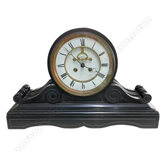A Victorian black slate mantel clock - platform and scrolled base, the white enamel dial with Roman numerals and open ascapment. W.560mm.