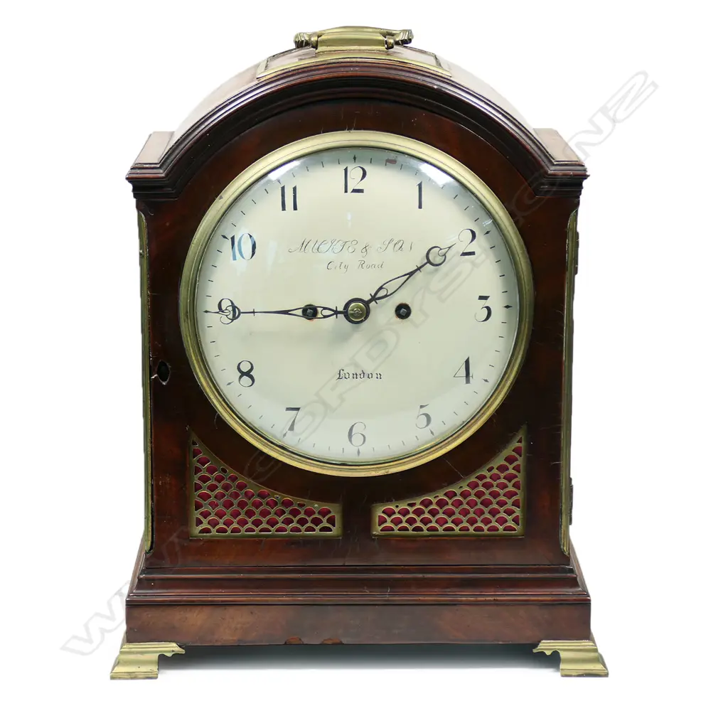A late 18th century mahogany bracket clock by George Mackie & Son, City Road, London - with 8-day twin-fusee, engraved movement, striking the hours on a bell, pendulum lock screw absent, with winding and door keys. The case of break arch form with carry handle, with circular convex repainted dial, with Arabic numerals, original brass scale fretwork to lower quarters and the sides, arched glazed door to rear, standing on brass ogee bracket feet. H.395mm, Image 1++