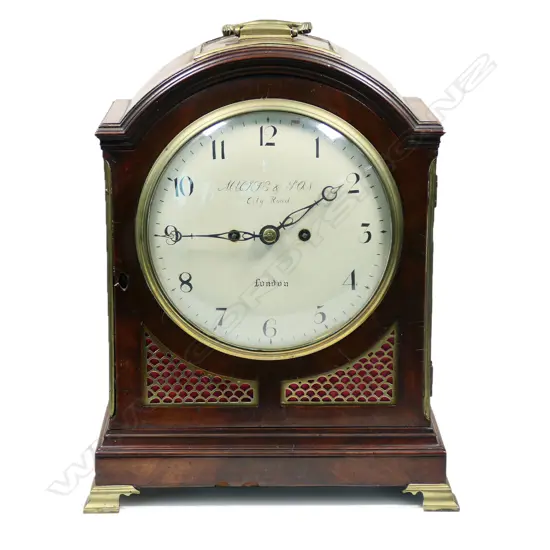 A late 18th century mahogany bracket clock by George Mackie & Son, City Road, London - with 8-day twin-fusee, engraved movement, striking the hours on a bell, pendulum lock screw absent, with winding and door keys. The case of break arch form with carry handle, with circular convex repainted dial, with Arabic numerals, original brass scale fretwork to lower quarters and the sides, arched glazed door to rear, standing on brass ogee bracket feet. H.395mm,