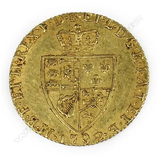 A 1792 gold spade guinea - 22ct gold, 8.4gms. Dia.24 mm. The reverse with crowned quartered shield of arms in the shape of a spade, legend around, date 1792 below. A good example.