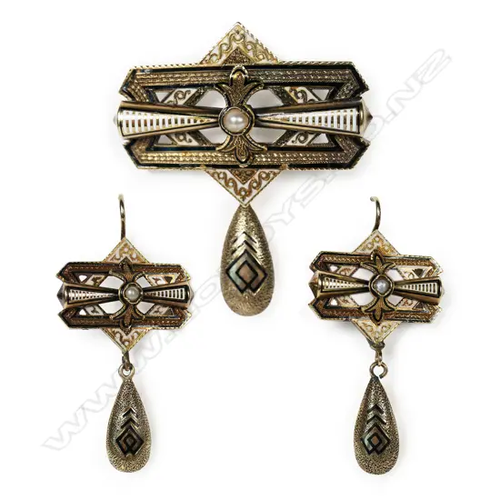 A good suite of late 19thC gold and enamel jewellery - comprising brooch and earrings. each with a pearl set tapered baton upon two layered geometric panels, with pendant drops. White and black enamelled highlights. Hooks for pierced ears. Testing as 14ct gold. 17.68gms.