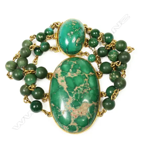 A 14ct gold and spiderweb variscite bracelet - a large oval variscite cabochon bezel set, with three gold chain and variscite bead strands connected to a push clasp set with a smaller oval variscite cabochon. Not marked but tests as 14ct.