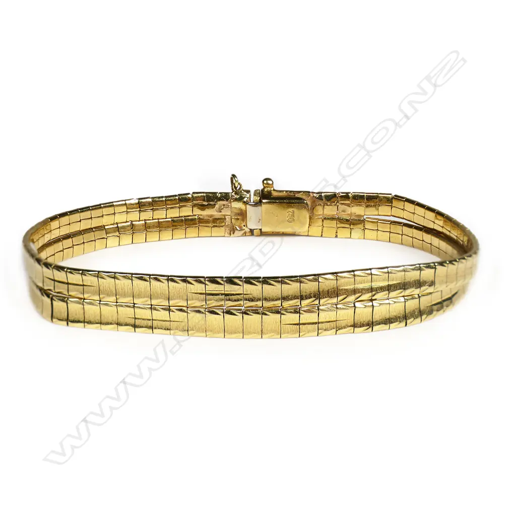An 18ct gold bracelet - two strands of articulated links in a brushed finish, push clasp with safety catch. 22.10gms. L.170mm. Valuation available. Image 1++