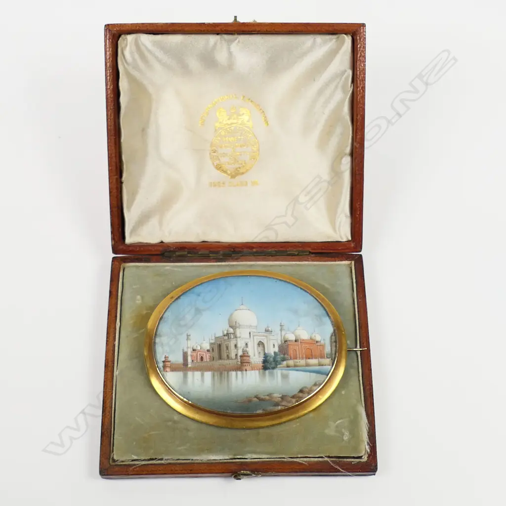 A 19thC gold framed large Grand Tour Taj Mahal painted ivory brooch - the glazed oval ivory panel with a finely detailed image reflecting in the foreground water. In gilded 14ct gold tested frame. W.70mm. In leather case 15.3gms. Image 1++