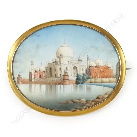 A 19thC gold framed large Grand Tour Taj Mahal painted ivory brooch - the glazed oval ivory panel with a finely detailed image reflecting in the foreground water. In gilded 14ct gold tested frame. W.70mm. In leather case 15.3gms.