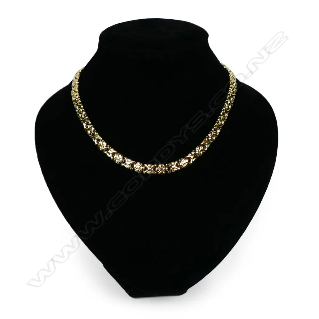 An 18ct gold necklace - alternating fancy flat links with push clasp and safety catch. Purchased in the up-market Ginza shopping district in Tokyo. In original presentation box. 33gms. Image 1++