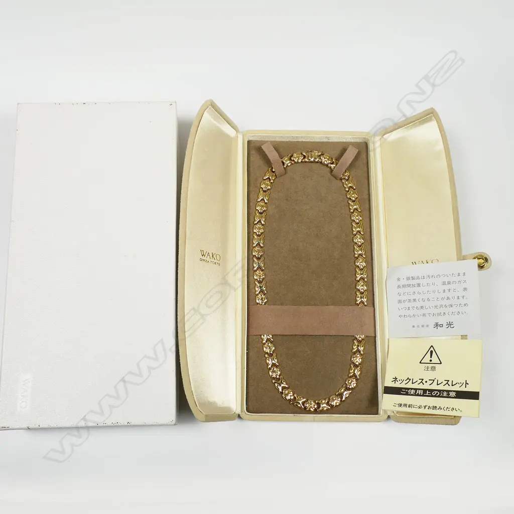 An 18ct gold necklace - alternating fancy flat links with push clasp and safety catch. Purchased in the up-market Ginza shopping district in Tokyo. In original presentation box. 33gms. Image 1++