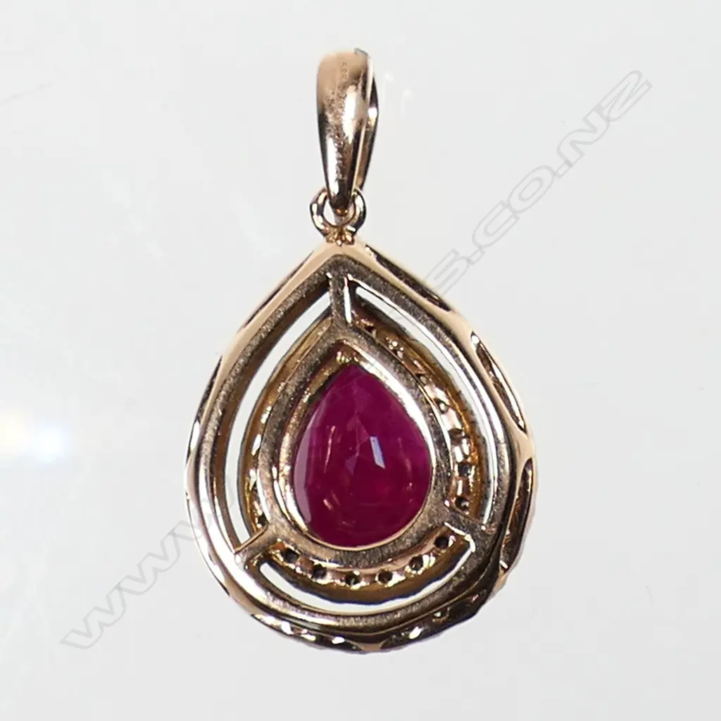 A 14ct rose gold ruby and champagne diamond double halo pendant - a 2.82ct pear facet cut pinkish-red ruby (included), claw set and surrounded by a double halo of fifty-one round brilliant cut champagne diamonds, claw set. TDW. 045ct. Image 1++
