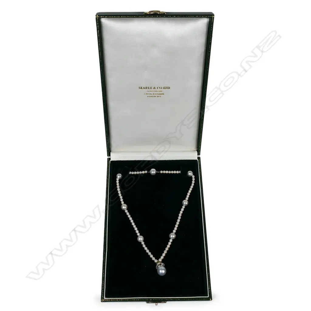 A pearl and diamond set necklace - a single strand of seventy-six 4mm Akoya type cultured pearls (white-pinkish with silver overtones and good lustre), with seven 10mm South Sea pearls (greyish-bluish with good lustre and moderate blemishes), interspersed with the smaller pearls, with a suspended 18ct white gold Bishop's mitre design pave set with diamonds supporting a 12mm bluish grey South Sea pearl. TDW. 0.31ct. The white gold clasp incorporated into one of the South Sea pearls. 39cm long Image 1++