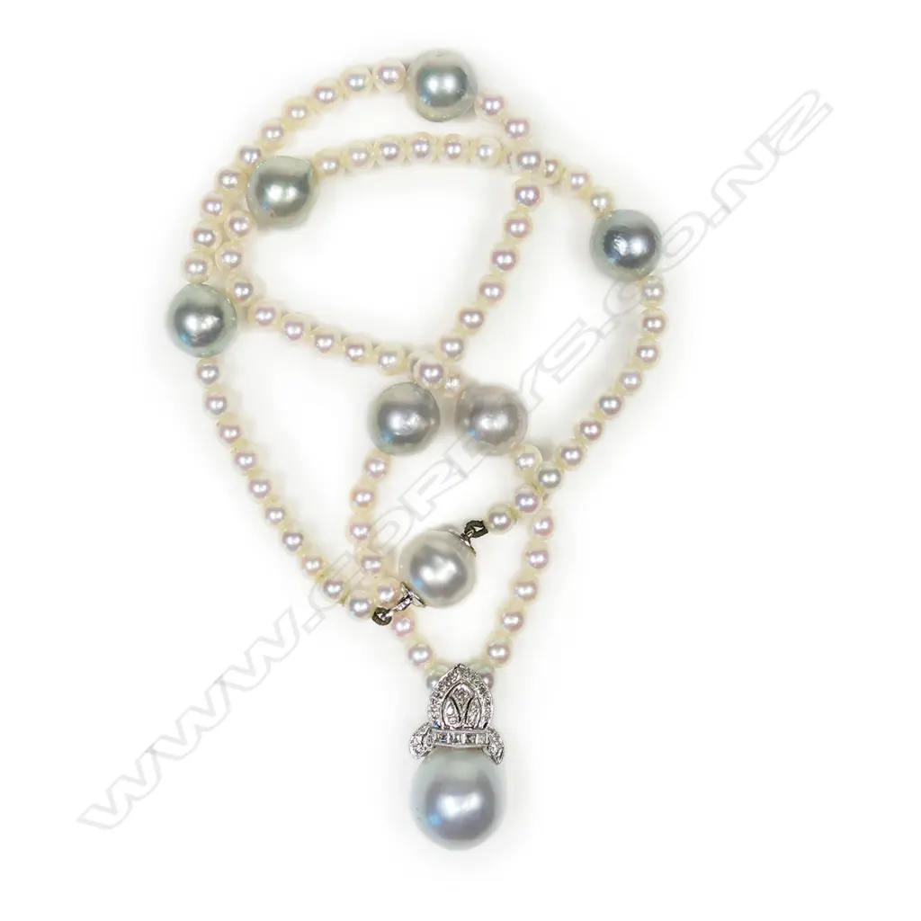 A pearl and diamond set necklace - a single strand of seventy-six 4mm Akoya type cultured pearls (white-pinkish with silver overtones and good lustre), with seven 10mm South Sea pearls (greyish-bluish with good lustre and moderate blemishes), interspersed with the smaller pearls, with a suspended 18ct white gold Bishop's mitre design pave set with diamonds supporting a 12mm bluish grey South Sea pearl. TDW. 0.31ct. The white gold clasp incorporated into one of the South Sea pearls. 39cm long Image 1++