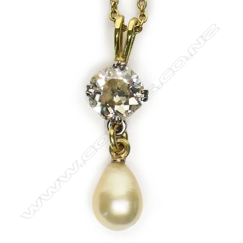 A solitaire 3ct+ old cut diamond set in an 18ct yellow gold necklace - the diamond of champagne tone with chipping to its edge, secured by four double claws with a large oval form cultured pearl below. The chain with repeating highlights of white gold links. 10.95gms. Chain L.500mm. Image 1++