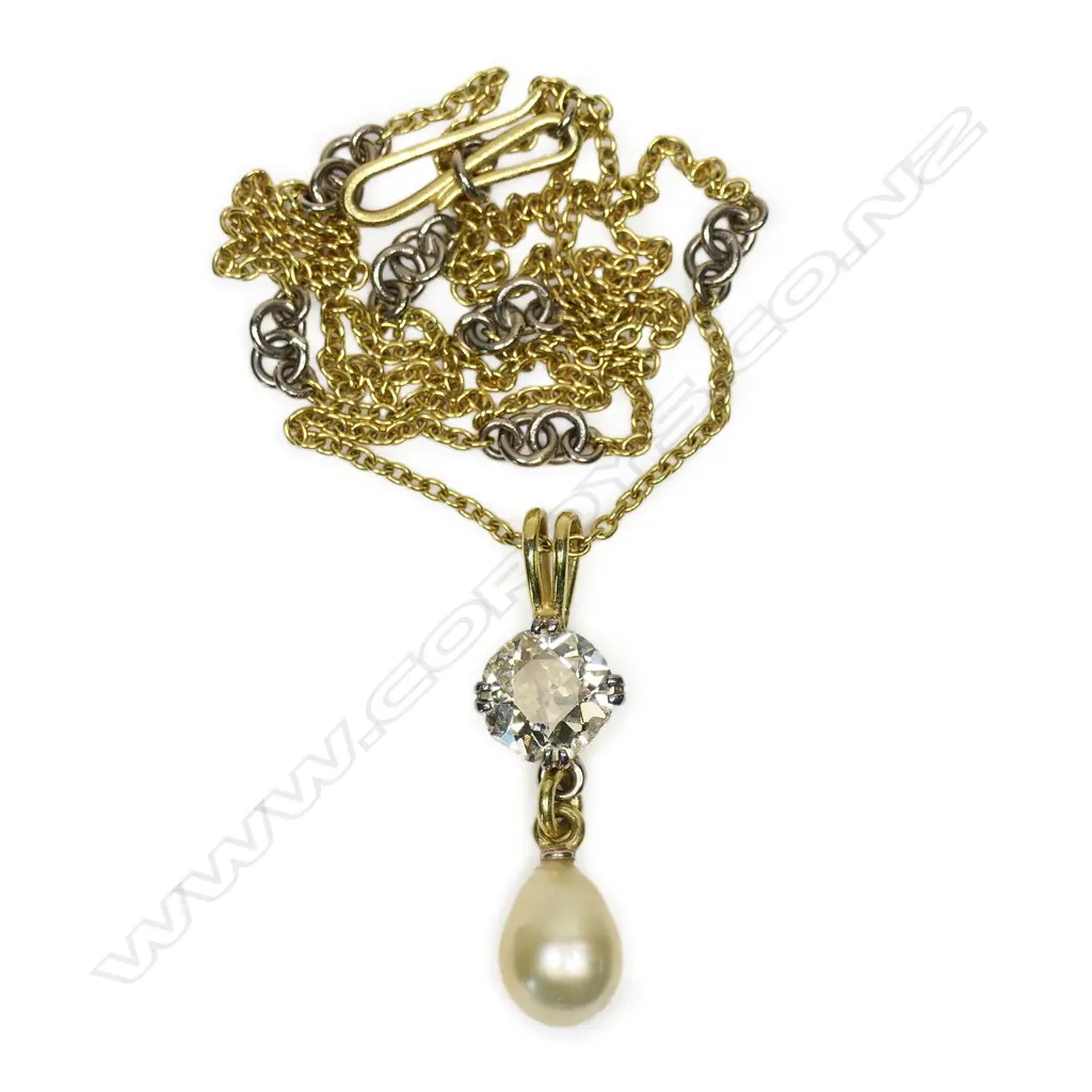 A solitaire 3ct+ old cut diamond set in an 18ct yellow gold necklace - the diamond of champagne tone with chipping to its edge, secured by four double claws with a large oval form cultured pearl below. The chain with repeating highlights of white gold links. 10.95gms. Chain L.500mm. Image 1++