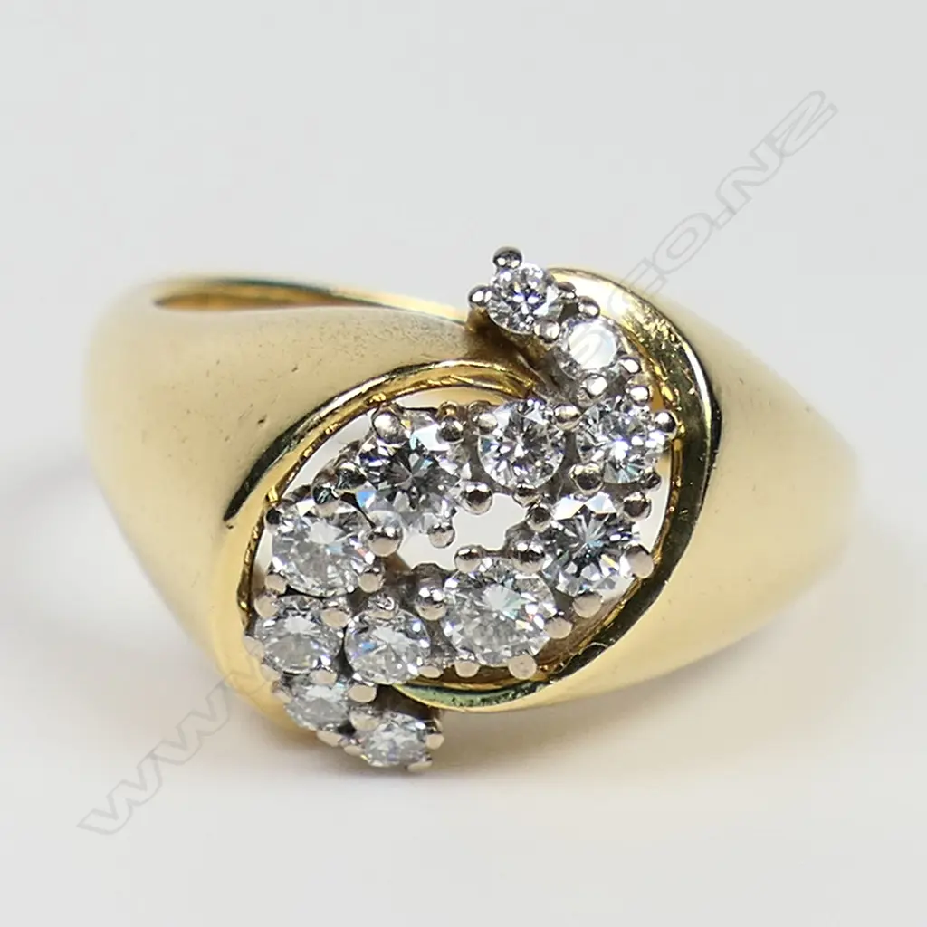 An estate heavy18ct yellow gold and diamond cluster ring - the 12 round brilliant cut diamonds claw set in white gold pillars in a cross-over setting. Wide tapered shoulders, 11.2gms. Valuation available. Image 1++