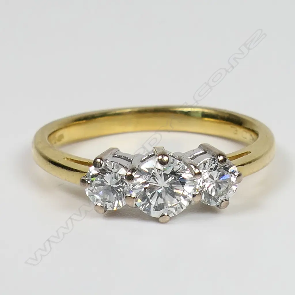 An 18ct gold and three stone diamond ring - a 0.57ct round brilliant cut diamond (Colour H, Clarity I1), claw set with a 0.28ct round brilliant cut diamond (Colour F-G, Clarity I1), claw set to each side. TDW. 1.13ct. Valuation available. Image 1++