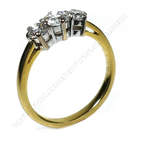 An 18ct gold and three stone diamond ring - a 0.57ct round brilliant cut diamond (Colour H, Clarity I1), claw set with a 0.28ct round brilliant cut diamond (Colour F-G, Clarity I1), claw set to each side. TDW. 1.13ct. Valuation available.
