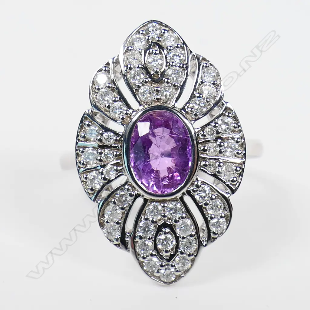 A 14ct white gold pink sapphire and diamond antique style ring - a 0.98ct oval cut pink sapphire(moderate natural inclusions), bezel set and embellished with forty-four round brilliant cut diamonds (Colour H-J, Clarity SI-I1) bead set. TDW. 0.45ct. Ring size K. Image 1++