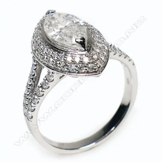 A 14ct white gold diamond double halo ring - a 1.06ct marquise cut diamond (Colour G-H, Clarity SI1-SI2), claw set and surrounded by a double halo of round brilliant cut diamonds with further diamonds set to the split shoulders (Colour H-H, Clarity SI1-SI2), micro bead set. TDW. 1.72ct. Ring size M.