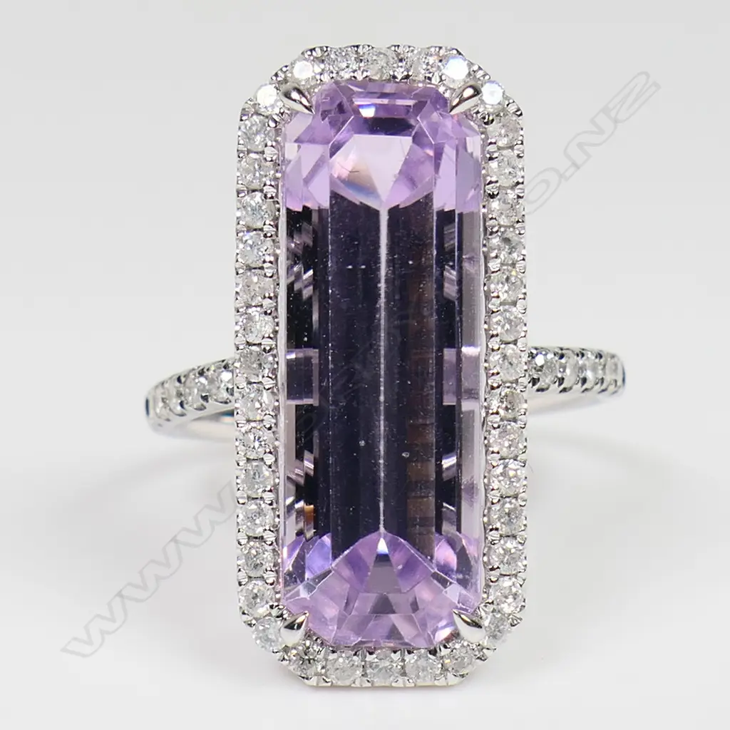 A 14ct white gold kunzite and diamond halo ring - a 9.37ct octagon cut purplish-pink kunzite (very minor eye visible inclusions), claw set and surrounded by a halo of round brilliant cut diamonds, with further diamonds set to the shoulders (Colour J-K, Clarity SI2-I2), micro claw set. TDW. 0.51ct. Ring size M½. Image 1++