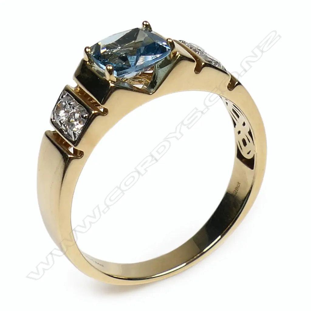 A 14ct yellow and white gold aquamarine and diamond ring - a 0.84ct cushion cut Santa Maria aquamarine (eye clean clarity), claw set, with two round brilliant cut diamonds (Colour J-K, Clarity SI1-S1), bead set in white gold to each shoulder. TDW. 0.28ct. Ring size Q ½. Image 1++