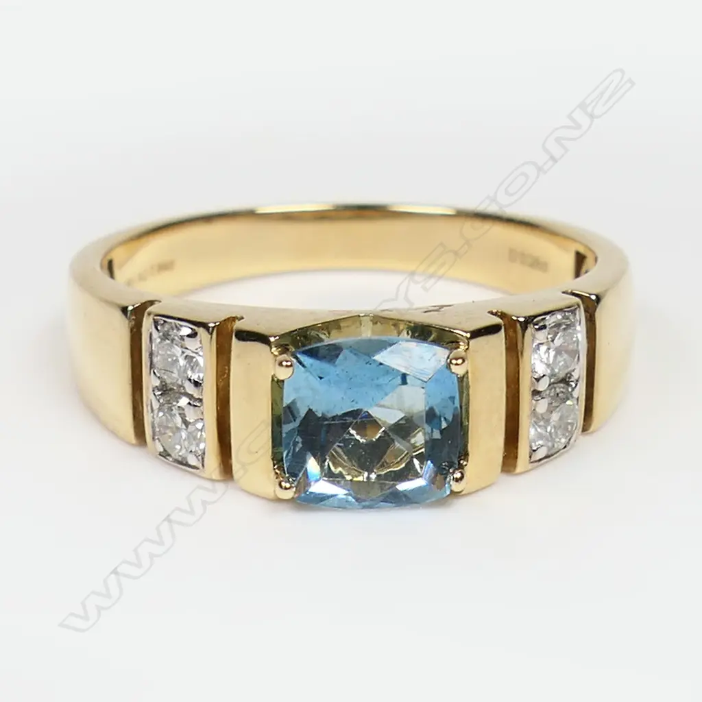 A 14ct yellow and white gold aquamarine and diamond ring - a 0.84ct cushion cut Santa Maria aquamarine (eye clean clarity), claw set, with two round brilliant cut diamonds (Colour J-K, Clarity SI1-S1), bead set in white gold to each shoulder. TDW. 0.28ct. Ring size Q ½. Image 1++