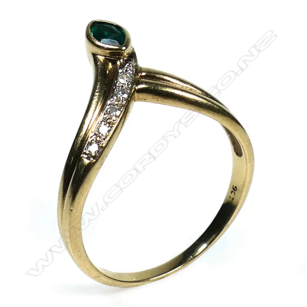 A 9ct gold emerald and diamond dress ring - a 0.30ct marquise cut moderate deep green emerald (lab created with eye clean clarity), bezel set, with five round eight cut diamonds (Colour H-I, Clarity P1), micro bead set, wishbone style. TDW. 0.08ct. Ring size P. Image 1++