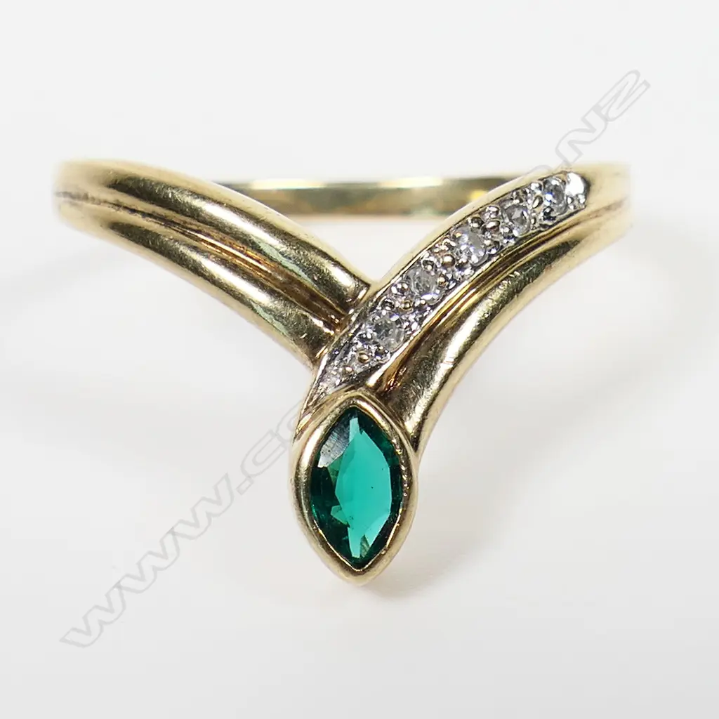 A 9ct gold emerald and diamond dress ring - a 0.30ct marquise cut moderate deep green emerald (lab created with eye clean clarity), bezel set, with five round eight cut diamonds (Colour H-I, Clarity P1), micro bead set, wishbone style. TDW. 0.08ct. Ring size P. Image 1++