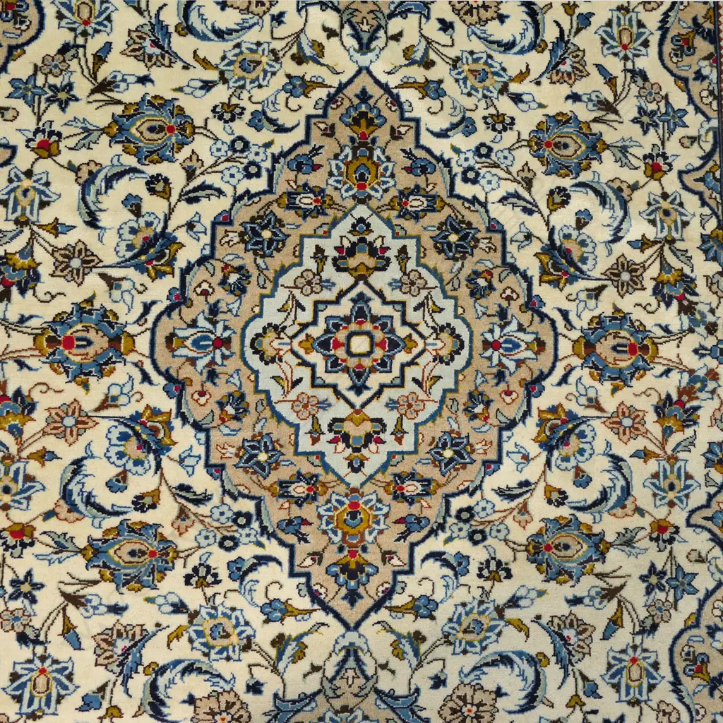 A quality hand-knotted Kashan carpet, the field decorated with a central medallion surrounded by flowing tendrils and conforming small medallions on an ivory ground, deep cream quadrants, multiple border guards. Image 1++