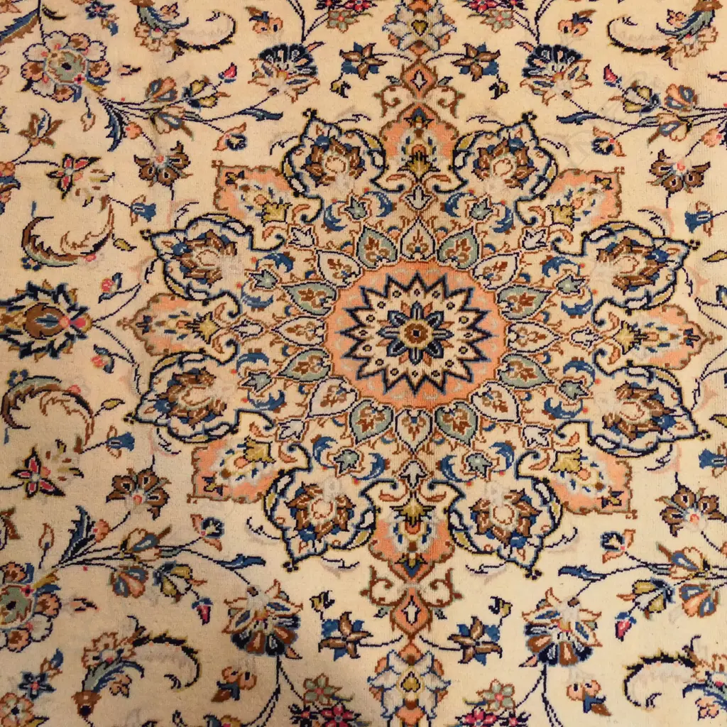 A fine quality hand-knotted Kashan carpet, the field decorated with multi-coloured flowering leafy tendrils surrounding a central medallion, on an ivory ground, multiple border guards with conforming decoration. 3400 x 2450mm. Image 1++