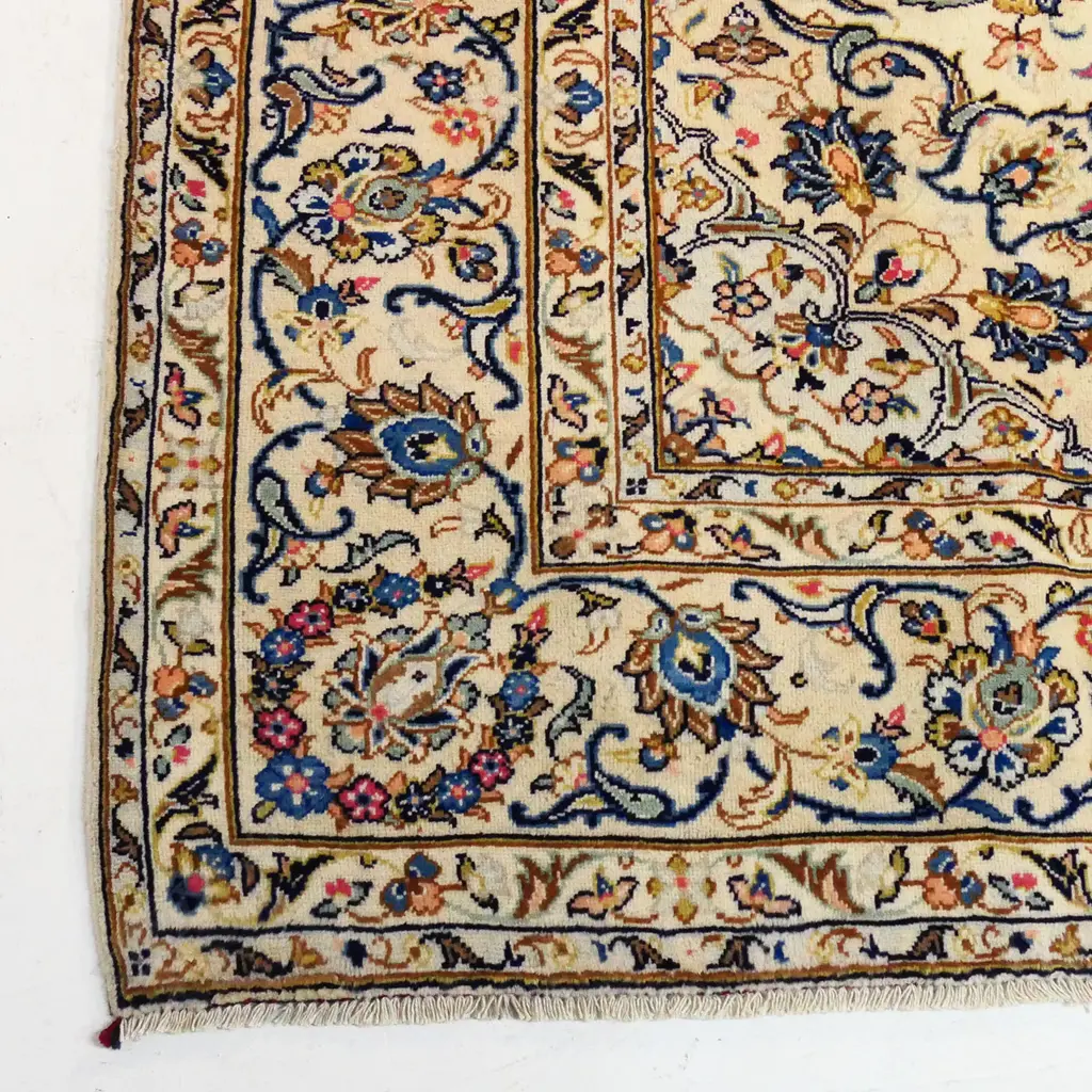 A fine quality hand-knotted Kashan carpet, the field decorated with multi-coloured flowering leafy tendrils surrounding a central medallion, on an ivory ground, multiple border guards with conforming decoration. 3400 x 2450mm. Image 1++