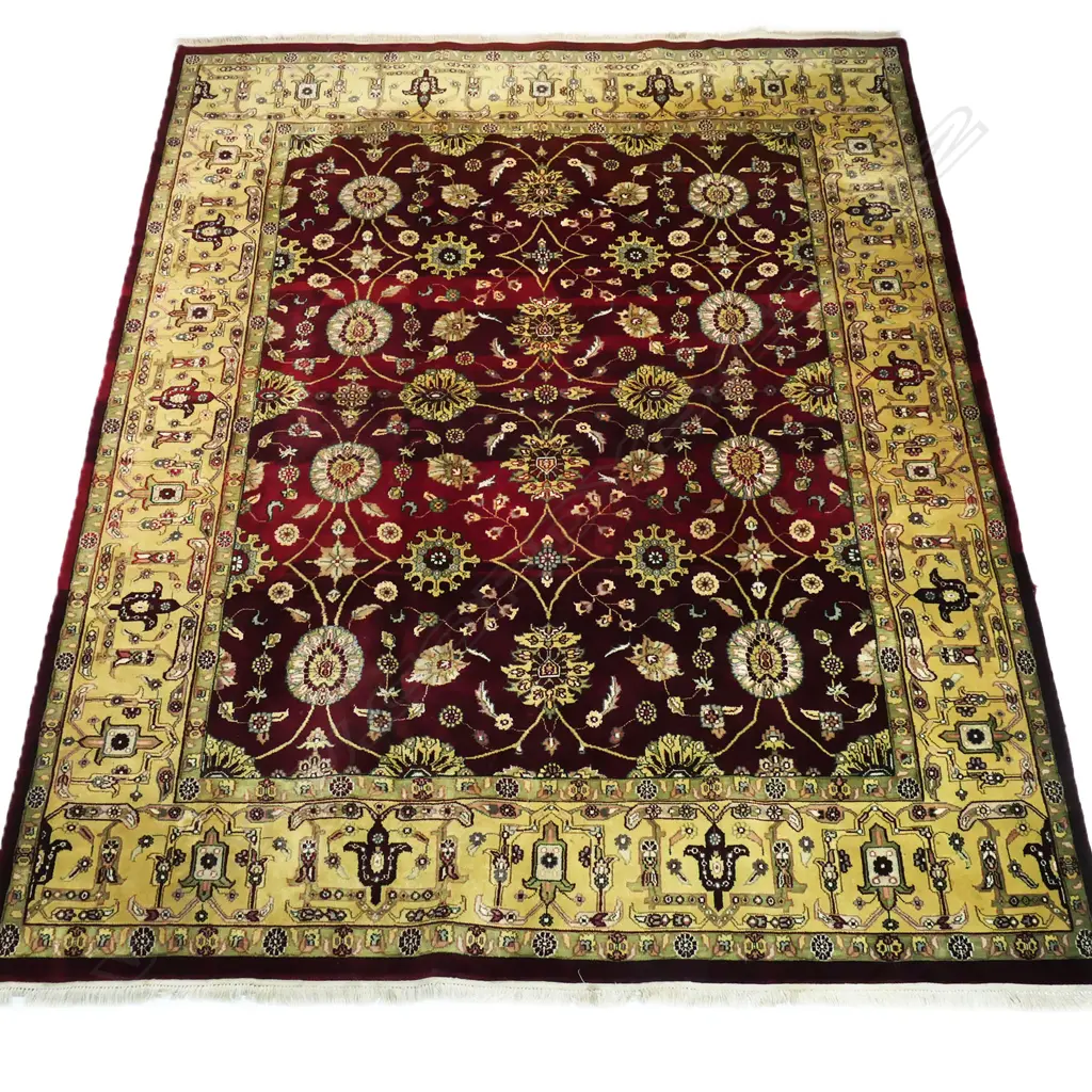 A large Indo-Persian hand-knotted wool on cotton rug, the maroon field decorated with floral medallions surrounded by flowering vines, multiple border guards with geometric shapes. (Retail $7,000 in 2014). 2400 x 3130mm. Image 1++