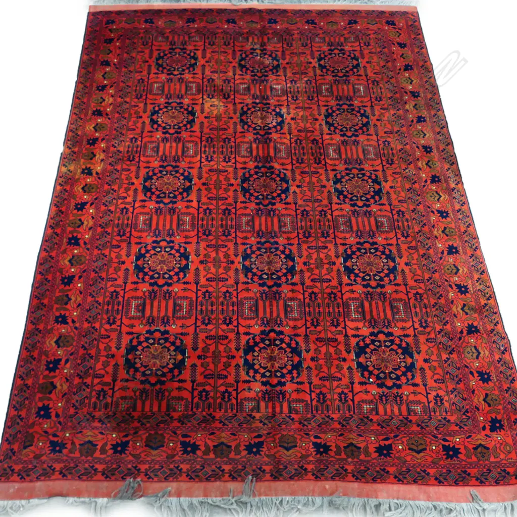 A fine hand-knotted wool rug,the field decorated with numerous medallions, surrounded by geometric stylised plants, multiple border guards. 2600 x 3700mm Image 1++