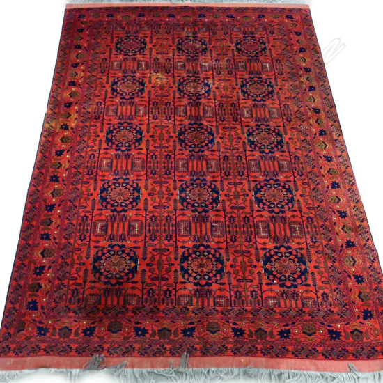 A fine hand-knotted wool rug,the field decorated with numerous medallions, surrounded by geometric stylised plants, multiple border guards. 2600 x 3700mm