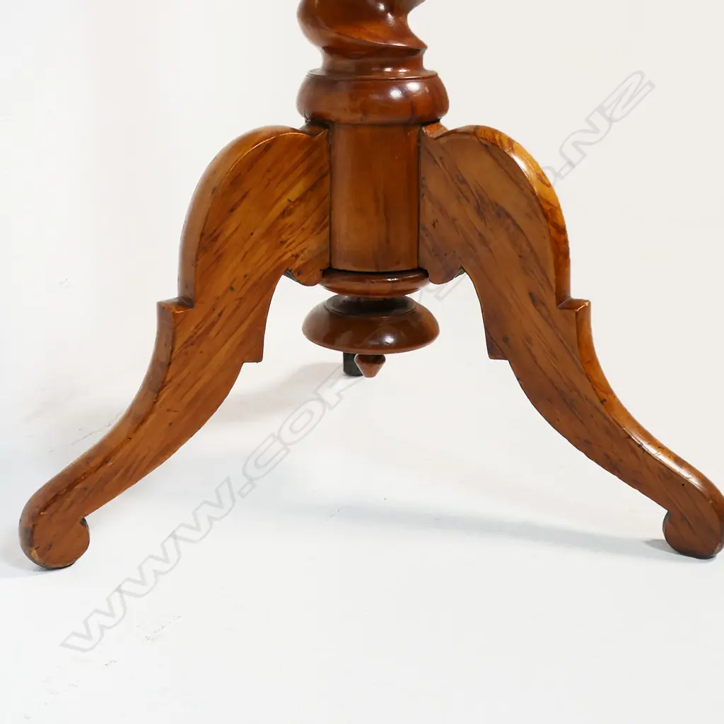 Anton Seuffert (1815-1887 New Zealand) fine and rare tilt-top specimen card table - the top with central multi-pointed starburst originating from a six-pointed star, on a fine rewarewa parquetry ground with traditional Seuffert scalloped border. The inlay of various N.Z. native timbers. On mottled Kauri tapering barley twist stem and three scroll legs. Dia.555mm. H.760mm. Image 1++