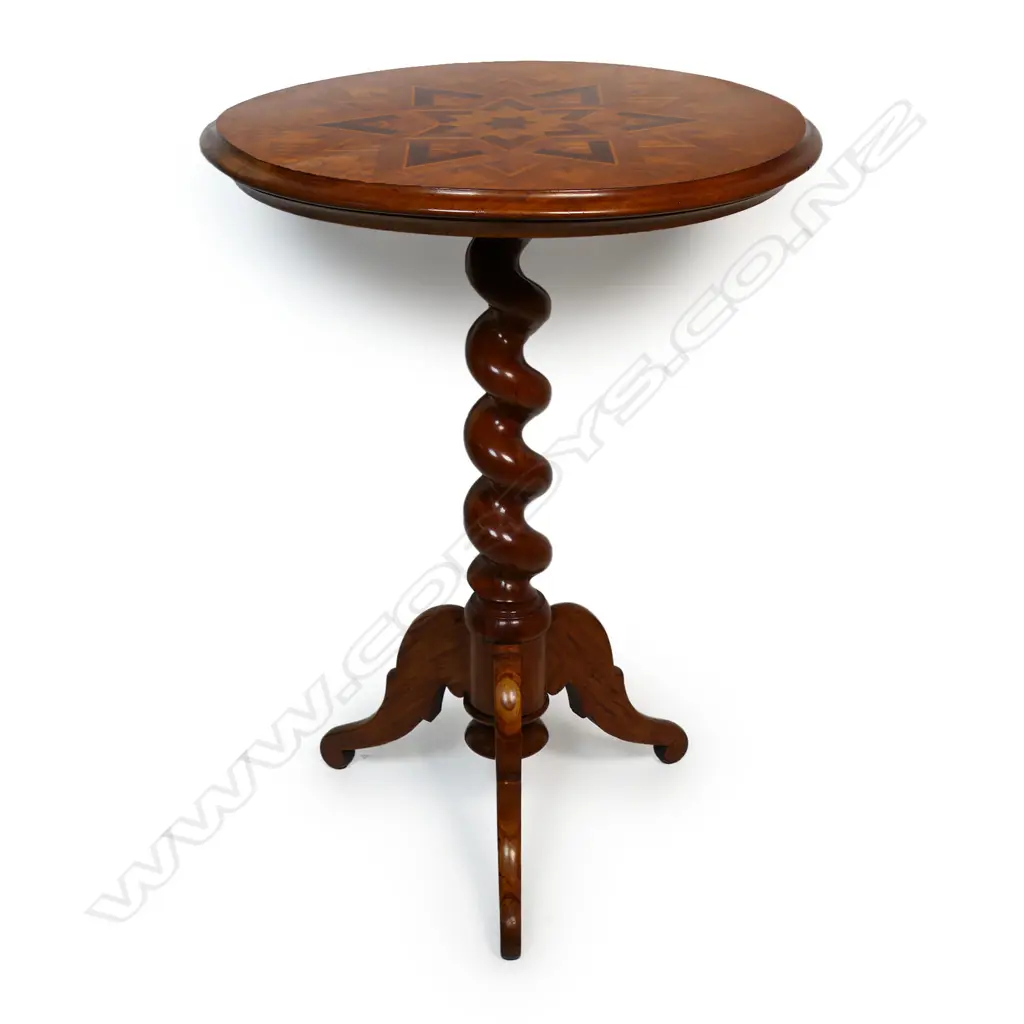 Anton Seuffert (1815-1887 New Zealand) fine and rare tilt-top specimen card table - the top with central multi-pointed starburst originating from a six-pointed star, on a fine rewarewa parquetry ground with traditional Seuffert scalloped border. The inlay of various N.Z. native timbers. On mottled Kauri tapering barley twist stem and three scroll legs. Dia.555mm. H.760mm. Image 1++