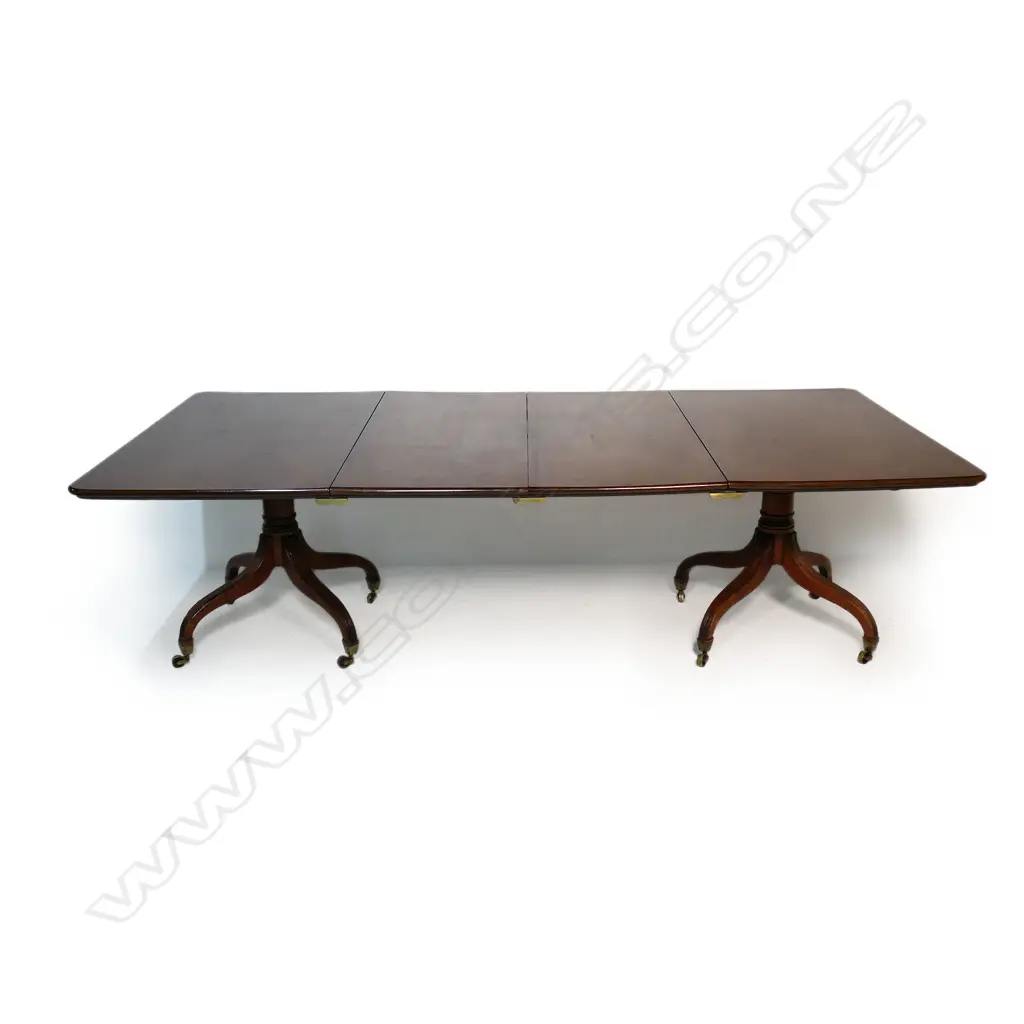 A Regency mahogany double pedestal dining table - with two extension leaves, brass casters. 1500 x 1300 x 730mm (2620mm when extended). Image 1++