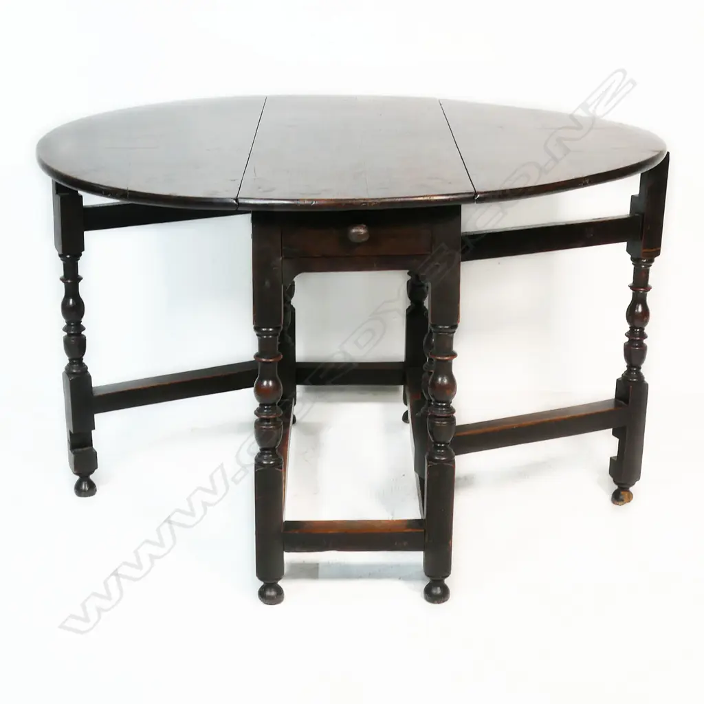 A George III country oak gate leg table - the drop sides raise on turned supports. 1120 x 1060 x 750mm. Image 1++