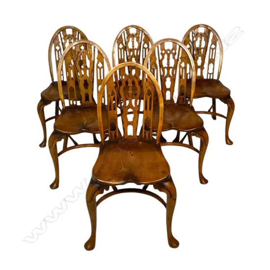 A set of six early 20thC Windsor style ash and elm hoop back chairs - the fancy ecclesiastical backs with three arches, crinoline stretchers and pad front feet.