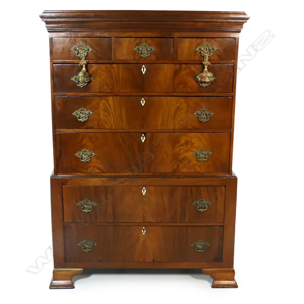 A mahogany Georgian style chest on chest - the top with three small drawers over three full width drawers, the base with two full width drawers, bone keyhole escutcheons, the pediment with restrained decoration, replacement brass handles, raised on bracket feet. 1030 x 530 x 1520mm. Image 1++