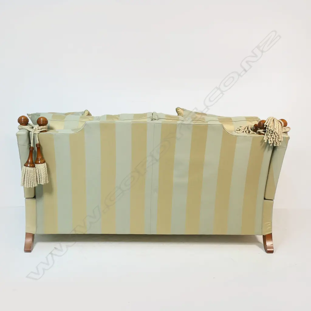 A Duresta designer 'Hornblower; two seater Knole sofa - upholstered in a striped muted gold and light teal fabric, with conforming wood and cord tassels, with separate cushions and substantial brass casters. Provenance: Purchased from Baran de Bourdeaux Fine Antiques. This piece has been in storage for a number of years. 1800 x 1160 x 900mm. Image 1++