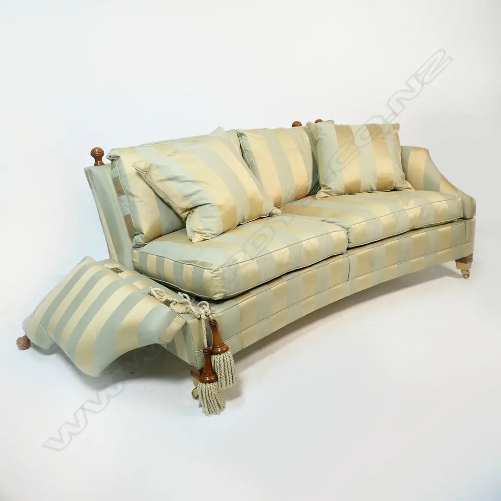 A Duresta designer 'Hornblower; two seater Knole sofa - upholstered in a striped muted gold and light teal fabric, with conforming wood and cord tassels, with separate cushions and substantial brass casters. Provenance: Purchased from Baran de Bourdeaux Fine Antiques. This piece has been in storage for a number of years. 1800 x 1160 x 900mm. Image 1++