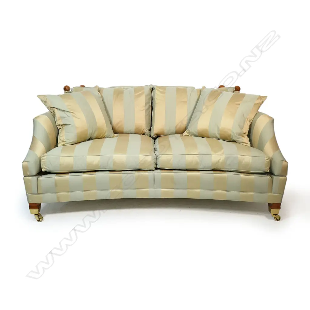 A Duresta designer 'Hornblower; two seater Knole sofa - upholstered in a striped muted gold and light teal fabric, with conforming wood and cord tassels, with separate cushions and substantial brass casters. Provenance: Purchased from Baran de Bourdeaux Fine Antiques. This piece has been in storage for a number of years. 1800 x 1160 x 900mm. Image 1++