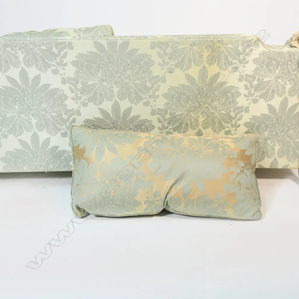 A Duresta designer three seater Knole sofa - upholstered in a self-patterned muted gold and light teal fabric, with conforming wood and cord tassels, (two faulted), with separate cushions and substantial brass casters. Provenance: Purchased from Baran de Bourdeaux Fine Antiques. This piece has been in storage for a number of years. 2300 x 1200 x 900mm. Image 1++