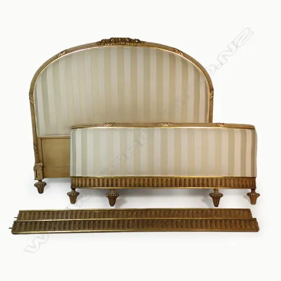 A French style double bed frame - the head and footboards with painted and gilded frame upholstered in an ivory and mushroom stripe. W.1520mm.