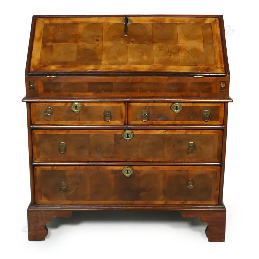 A George II walnut oyster shell veneer drop front bureau - the interior with traditional configuration plus storage well, the base of two half drawers over two full width drawers, raised on bracket feet. 840 x 480 x 980mm. Image 1++