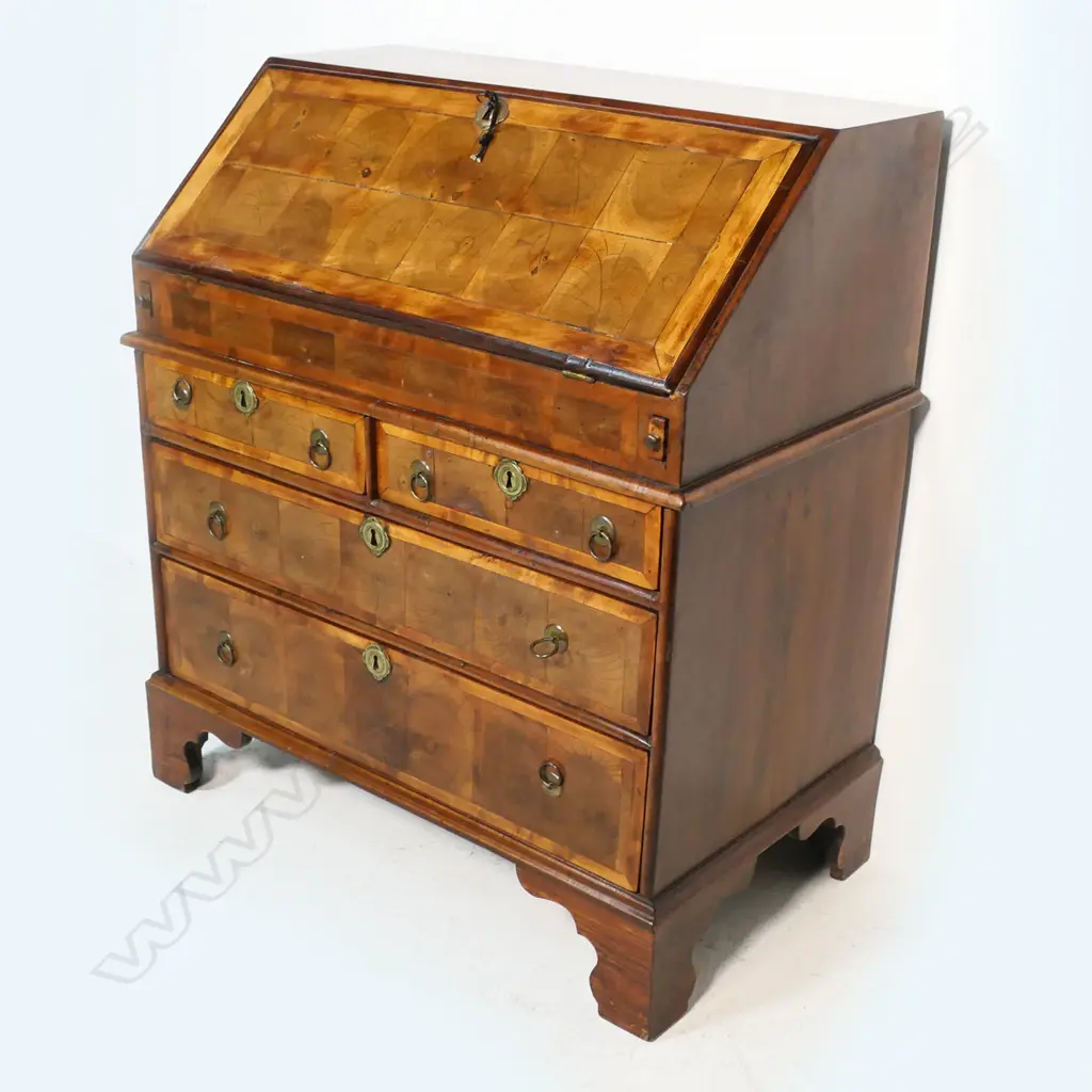 A George II walnut oyster shell veneer drop front bureau - the interior with traditional configuration plus storage well, the base of two half drawers over two full width drawers, raised on bracket feet. 840 x 480 x 980mm. Image 1++