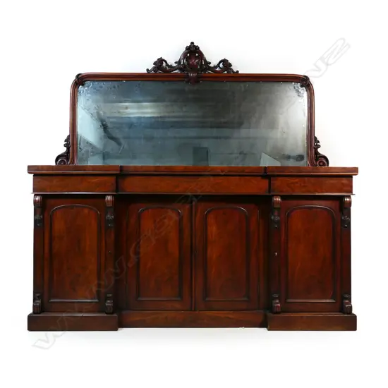 A quality Victorian mahogany mirror back sideboard - carved detail to the mirror back, the base with three drawers over a central cupboard, the side doors open to reveal shelves with one side containing a cellarette, raised on plinth base. 1820 x 580 x 1800mm. Some heat and/or water damage to the top.