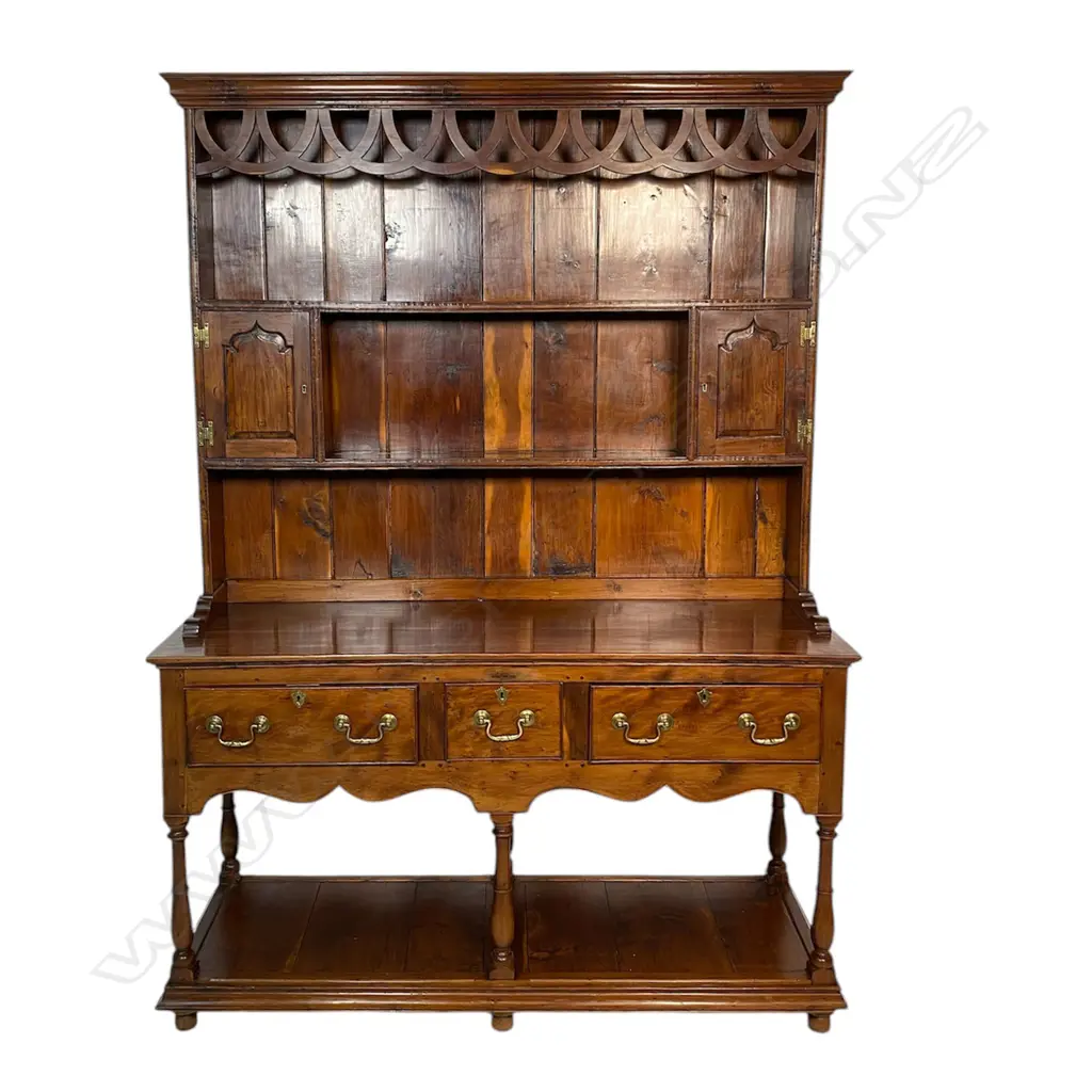 A quality George III style solid yew wood decorative plate rack back dresser - the back with over-looping frieze above two shelves and two small cupboards. The base with three frieze drawers and turned supports above the panelled lower shelf base. Traditionally made with some pegged construction. Oak lined. In good polish. 1360 x 470 x 1880mm. Image 1++